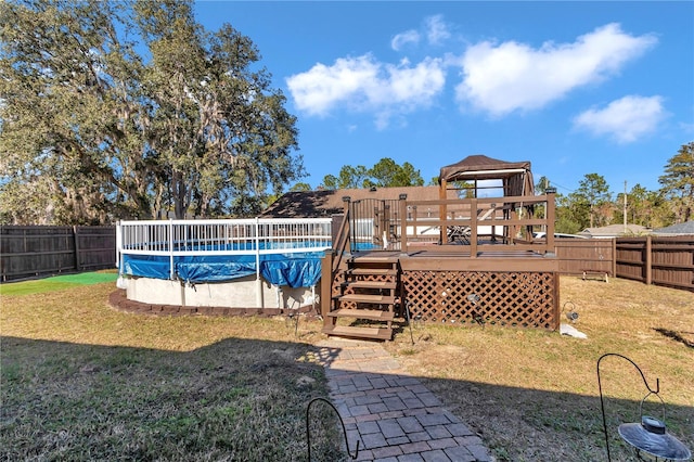 view of pool with a wooden deck, a gazebo, and a lawn