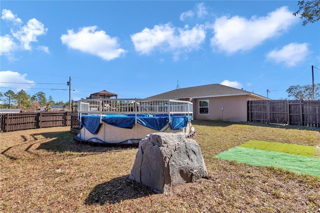 view of yard with a covered pool