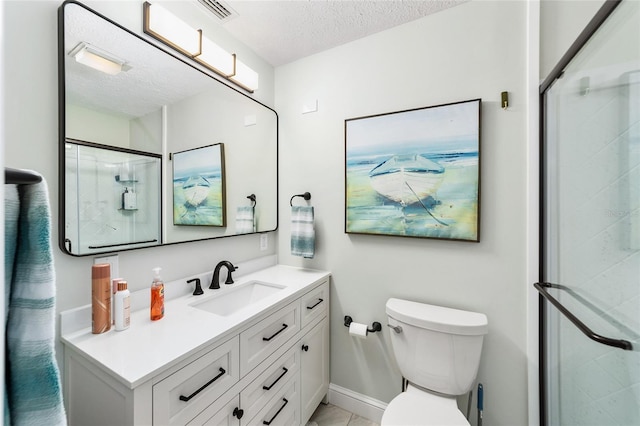 bathroom featuring a textured ceiling, walk in shower, vanity, and toilet