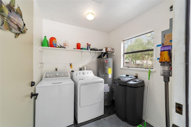 clothes washing area with washer and clothes dryer and water heater