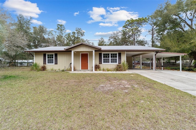 view of front of home with a front yard and a carport