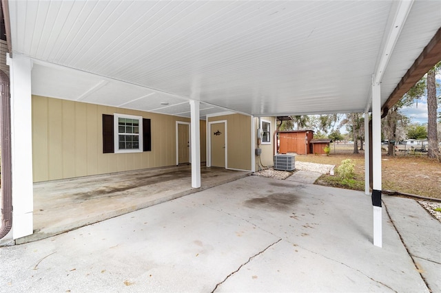 view of patio / terrace with central AC unit and a storage unit