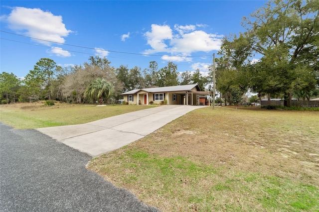 ranch-style house featuring a carport and a front yard