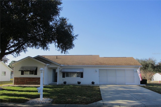 ranch-style house with a garage and a front lawn