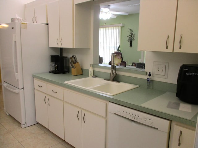 kitchen featuring white appliances, white cabinets, light tile patterned floors, and sink