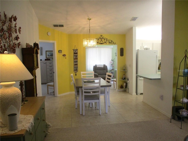 dining room with an inviting chandelier and light tile patterned flooring