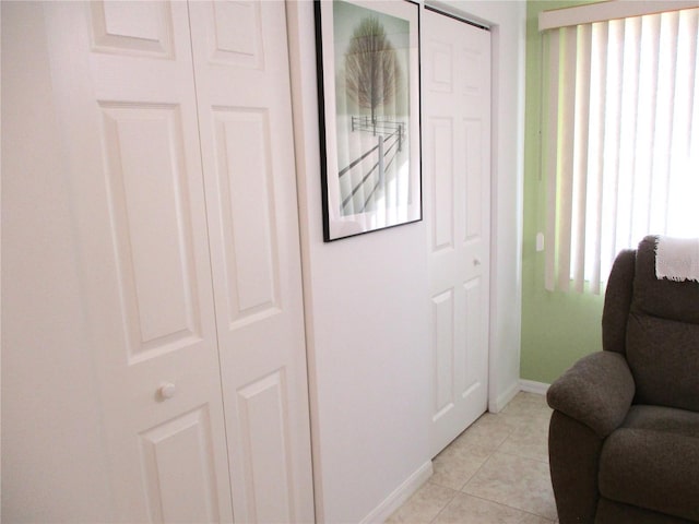 sitting room featuring light tile patterned floors and plenty of natural light