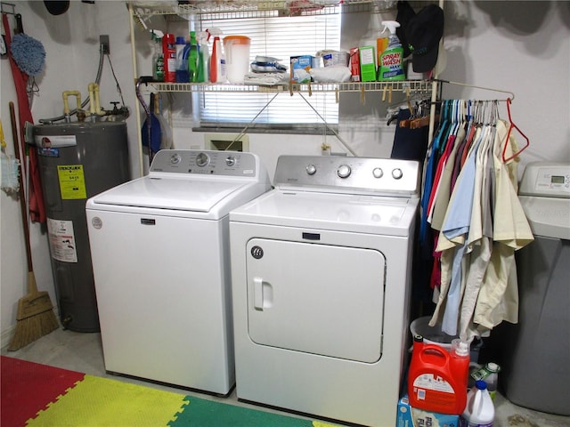 laundry area featuring water heater and separate washer and dryer