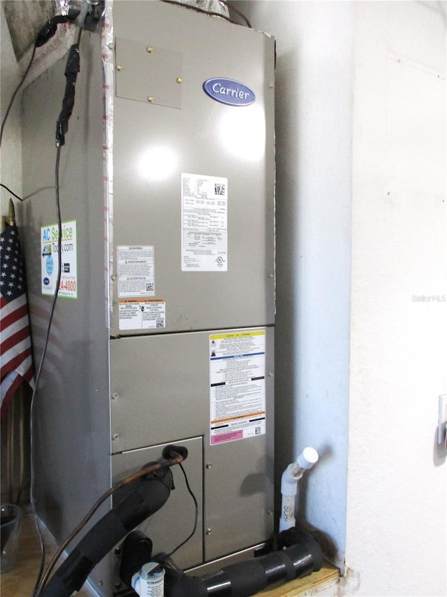 utility room featuring heating unit