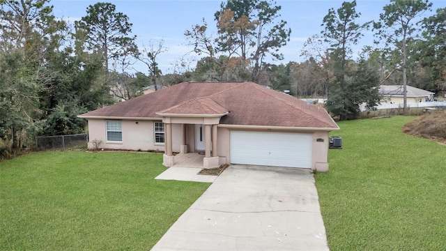 ranch-style home with a front yard, a garage, and central AC unit