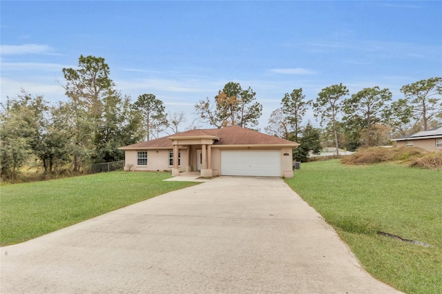 view of front of home with a front yard and a garage