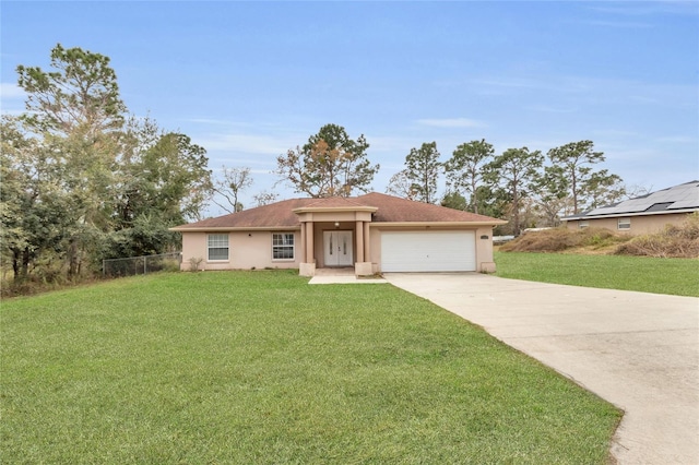 view of front of house with a garage and a front lawn