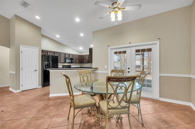 dining room with lofted ceiling, ceiling fan, french doors, and light tile patterned floors