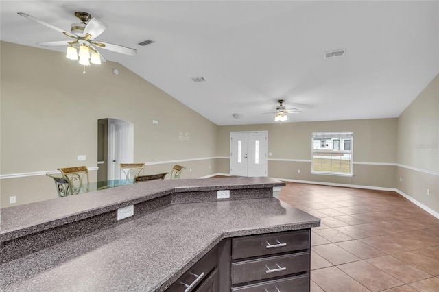 kitchen with vaulted ceiling, ceiling fan, and light tile patterned floors