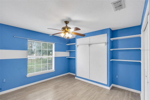 unfurnished bedroom featuring ceiling fan and light wood-type flooring