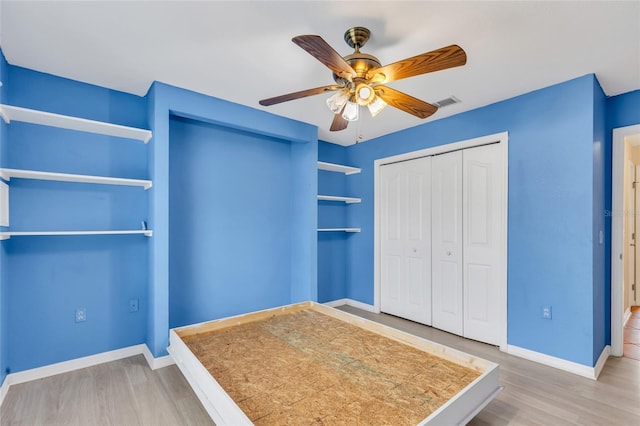 unfurnished bedroom featuring a closet, ceiling fan, and hardwood / wood-style flooring