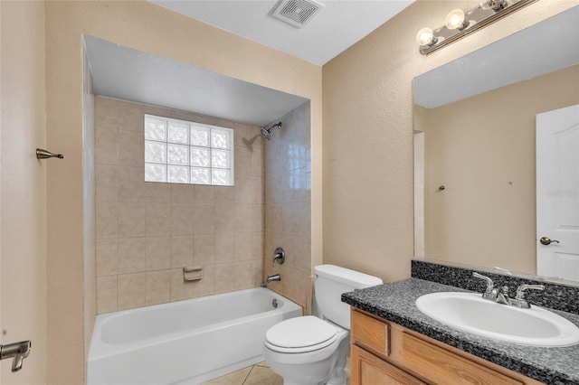 full bathroom with toilet, vanity, tile patterned floors, and tiled shower / bath combo