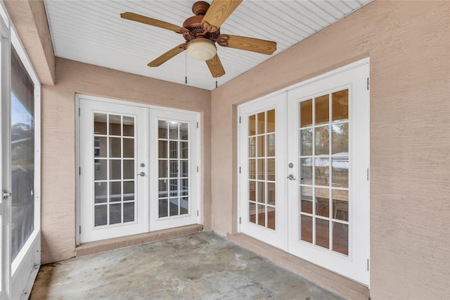 unfurnished sunroom featuring ceiling fan and french doors