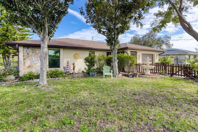 ranch-style home featuring a garage and a front lawn