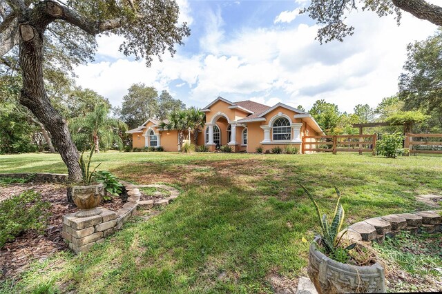 mediterranean / spanish house with a front lawn