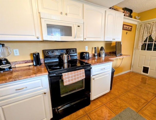 kitchen with black electric range oven, light tile patterned floors, white cabinetry, a textured ceiling, and stone countertops