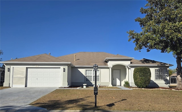 view of front of house with a front lawn and a garage