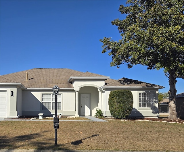 view of front facade with a front lawn and a garage