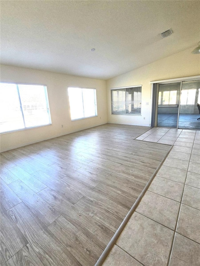 empty room featuring a textured ceiling and light wood-type flooring