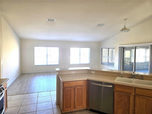 kitchen with stainless steel dishwasher, lofted ceiling, sink, and light tile patterned floors