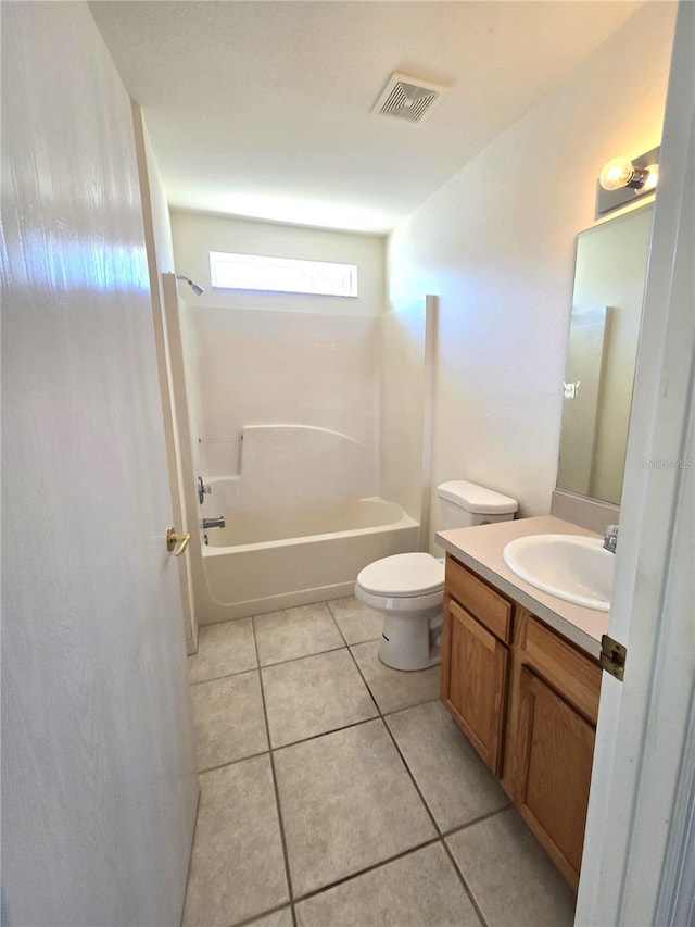 full bathroom with washtub / shower combination, tile patterned flooring, vanity, and toilet