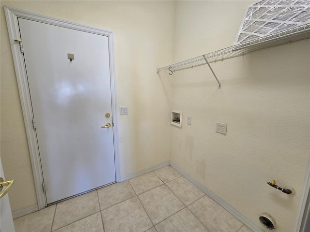 laundry room with hookup for a washing machine and light tile patterned floors