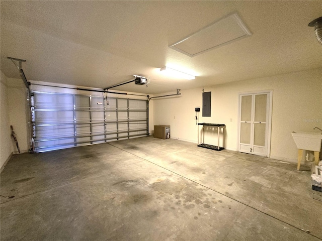 garage with a garage door opener and electric panel