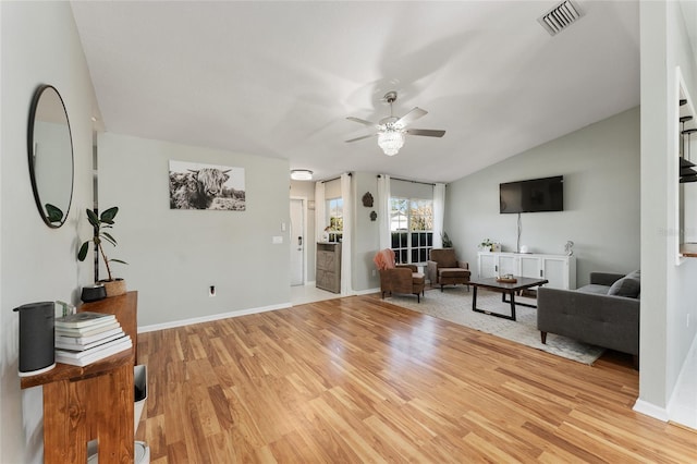 living room with vaulted ceiling, ceiling fan, and light hardwood / wood-style floors