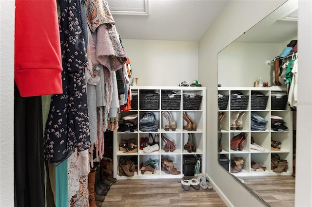 walk in closet with hardwood / wood-style floors