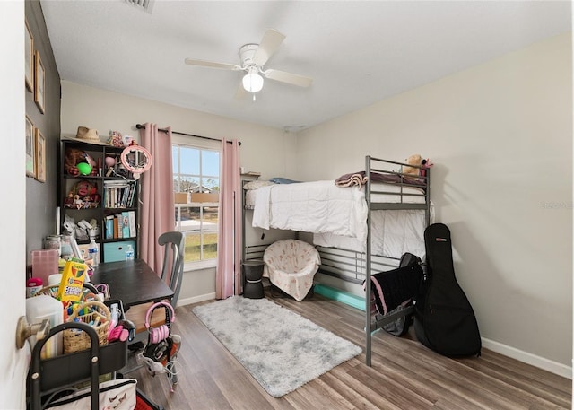 bedroom featuring hardwood / wood-style flooring and ceiling fan