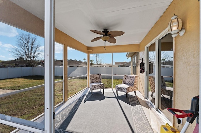 sunroom featuring ceiling fan