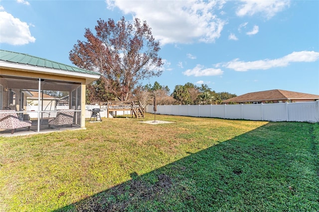 view of yard featuring a sunroom and a patio