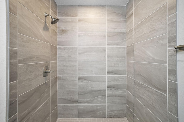 bathroom with a tile shower