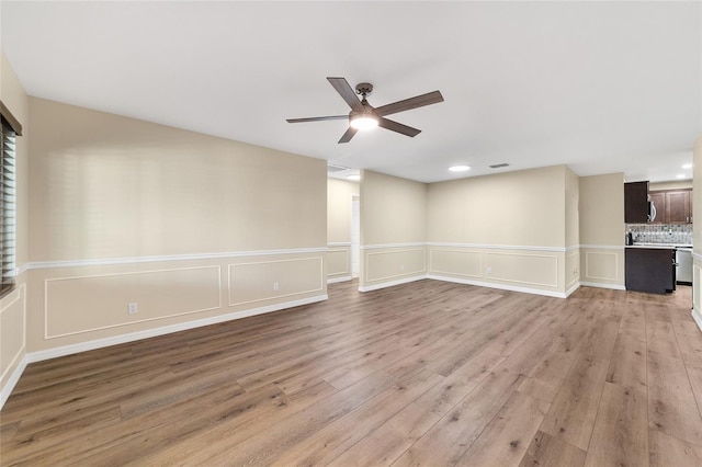 unfurnished living room with ceiling fan and light hardwood / wood-style flooring