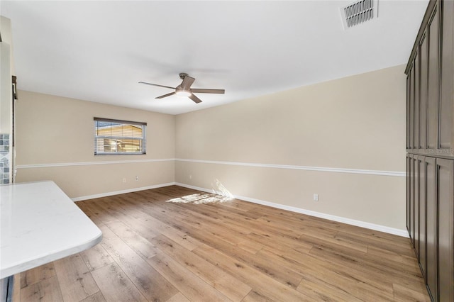 unfurnished dining area with light wood-type flooring and ceiling fan