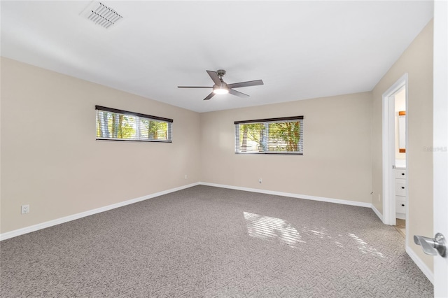 unfurnished room featuring ceiling fan and carpet