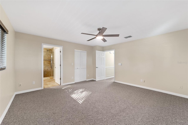 unfurnished bedroom with ensuite bathroom, ceiling fan, and light carpet