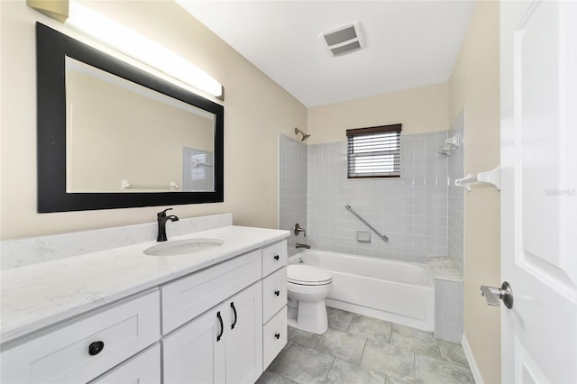 full bathroom featuring toilet, vanity, and tiled shower / bath combo