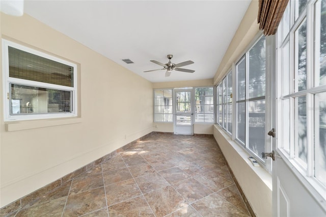 unfurnished sunroom with ceiling fan