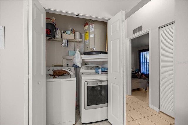 laundry room with light tile patterned flooring and separate washer and dryer