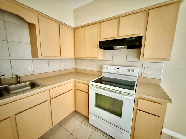 kitchen with sink, light brown cabinetry, and white electric range oven