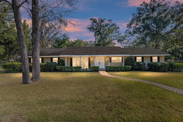 ranch-style house featuring a lawn