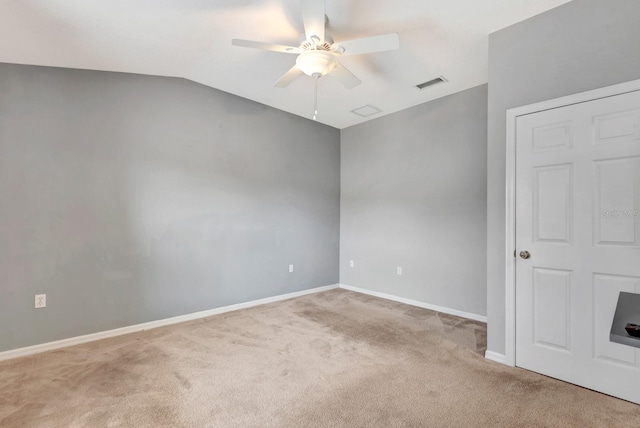 empty room featuring ceiling fan, light colored carpet, and lofted ceiling