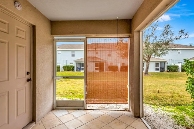 doorway to outside featuring light tile patterned floors