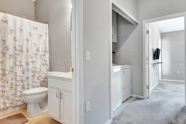 bathroom featuring washer and dryer, tile patterned floors, vanity, and toilet